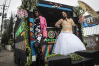 Two dancers stand on the back of a truck as a DJ inside the vehicle plays loud music to energize local voters as part of the non-partisan "Joy To The Polls" project on Tuesday, Dec. 6, 2022, in Atlanta. Sen. Raphael Warnock is running against Republican candidate and football legend Herschel Walker. (AP Photo/Ron Harris)