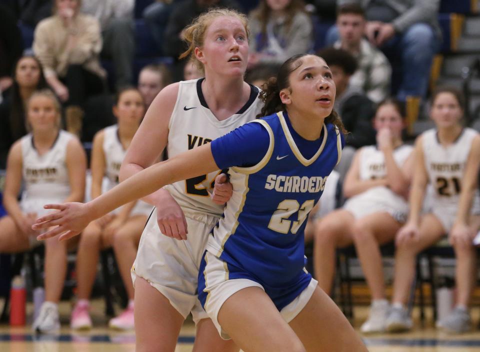 Schroeder's Gabriala Watkins boxes out Victor's Abbie Murphy on a foul shot.