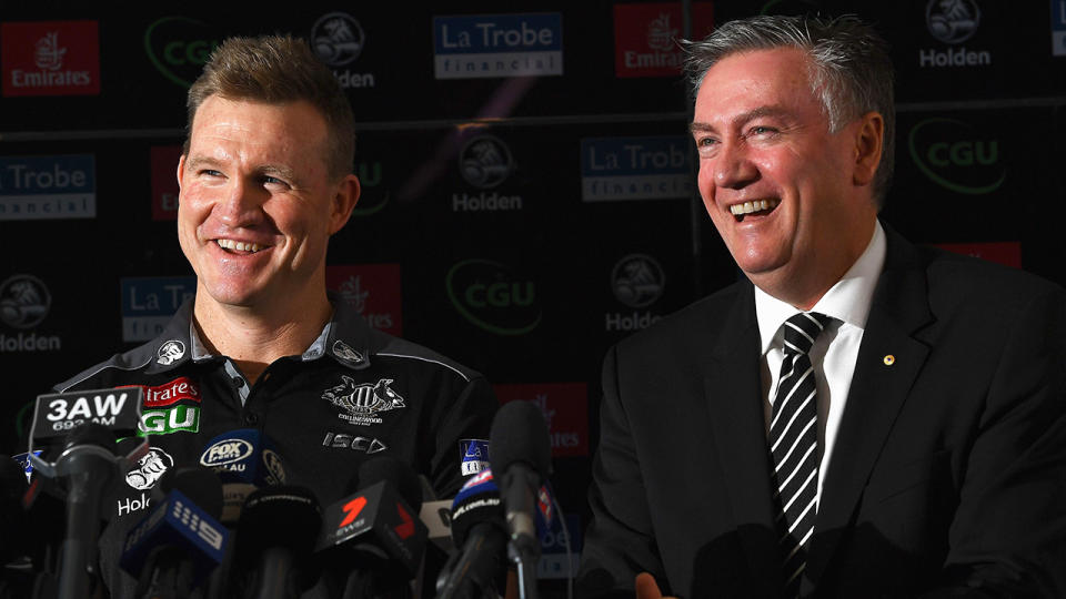 Nathan Buckley and Eddie McGuire are pictured laughing during a press conference.