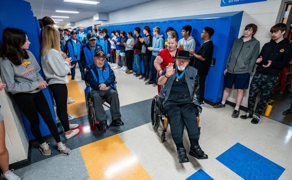 Students line the hallways of Oak Creek High School to honor fifteen Vietnam veterans, all graduates of Oak Creek High School before their Stars and Stripes Honor Flight.