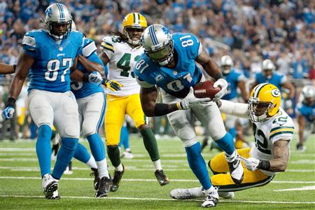 Detroit Lions wide receiver Calvin Johnson (81) scores a touchdown during the third quarter against the Green Bay Packers during a NFL football game on Thanksgiving at Ford Field. Mandatory Credit: Tim Fuller-USA TODAY Sports