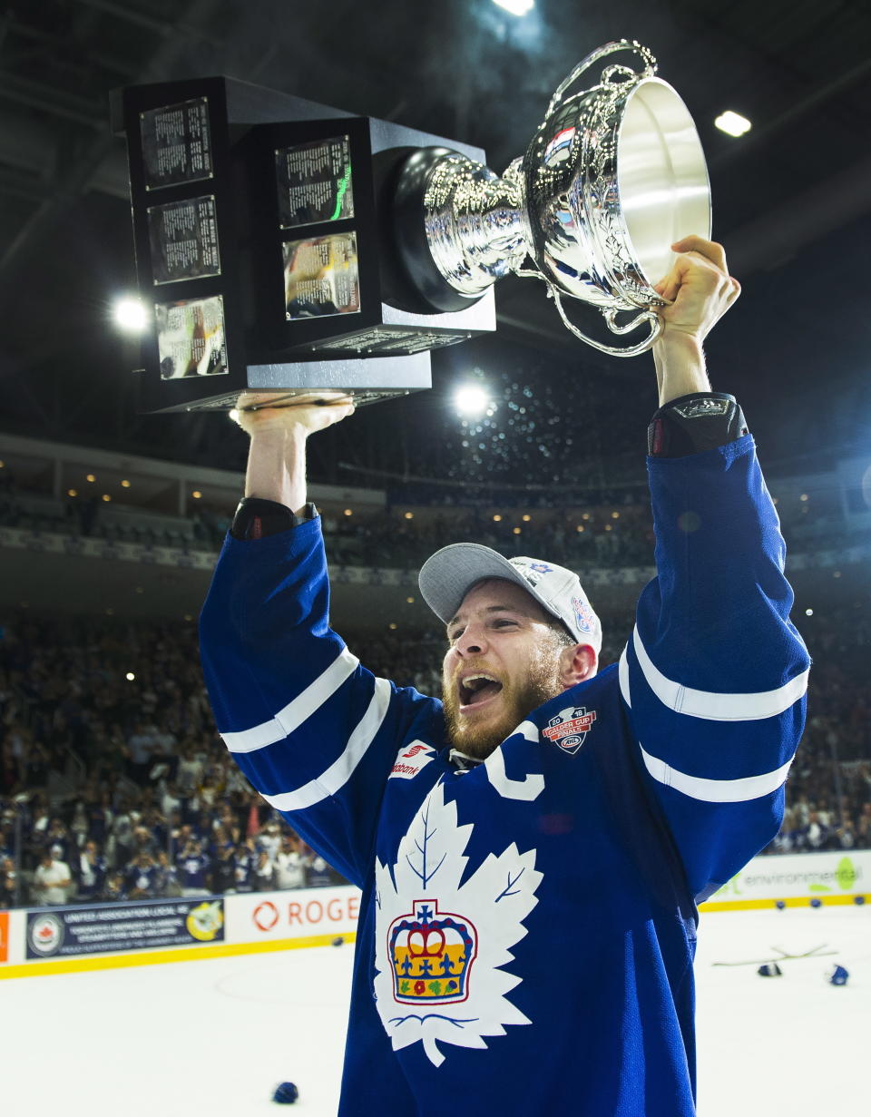 FILE - In this June 14, 2018, file photo, Toronto Marlies right wing Ben Smith hoists the Calder Cup after Game 7 of the AHL Calder Cup final against the Texas Stars in Toronto. The American Hockey League has canceled the rest of its season because of the coronavirus pandemic. President and CEO David Andrews announced the league ‘has determined that the resumption and completion of the 2019-20 season is not feasible in light of current conditions.’ The AHL's Board of Governors made that determination in a conference call Friday, May 8, 2020. (Nathan Denette/The Canadian Press via AP, File)