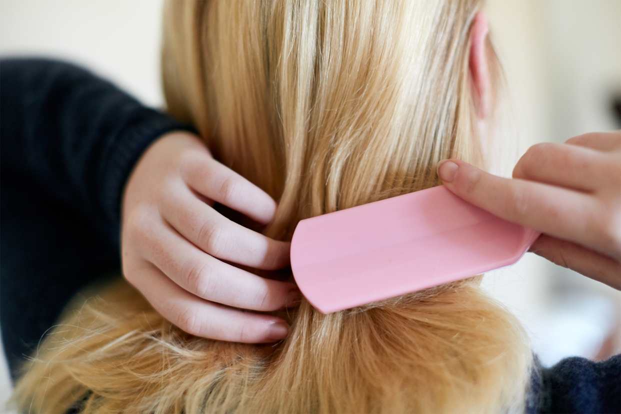 Woman combing hair