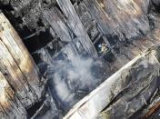 A firefighter searches for missing people inside a lithium battery manufacturing factory following a fire in Hwaseong, South Korea, Monday, June 24, 2024. (Newsis/ via AP)