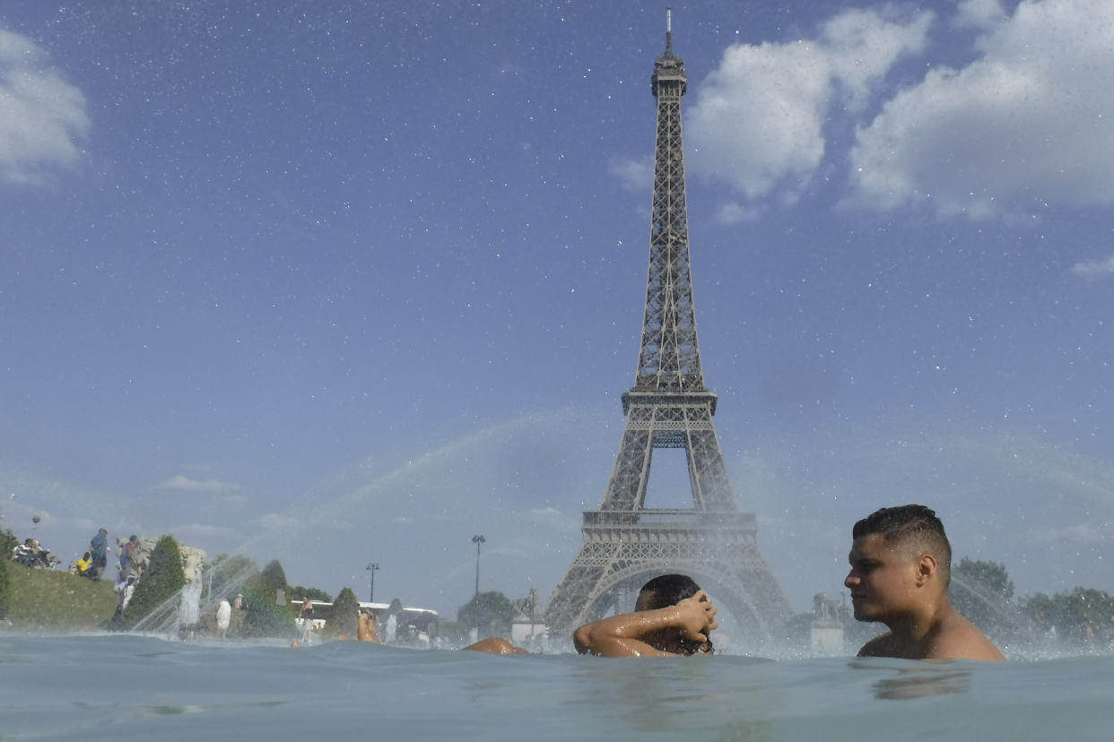 People cool off in the fountain of the Trocadero in Paris (AP Photo/Alessandra Tarantino)