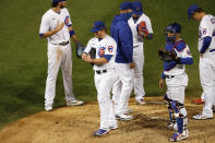 Chicago Cubs relief pitcher Craig Kimbrel, second from left, is taken out of the baseball game by manager David Ross during the ninth inning against the Kansas City Royals on Tuesday, Aug. 4, 2020, in Chicago. The Cubs won 5-4. (AP Photo/Charles Rex Arbogast)