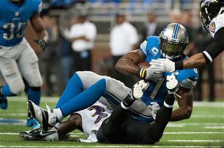 Dec 16, 2013; Detroit, MI, USA; Detroit Lions wide receiver Calvin Johnson (81) is tackled by Baltimore Ravens strong safety James Ihedigbo (32) and cornerback Jimmy Smith (22) during the fourth quarter at Ford Field. Mandatory Credit: Tim Fuller-USA TODAY Sports