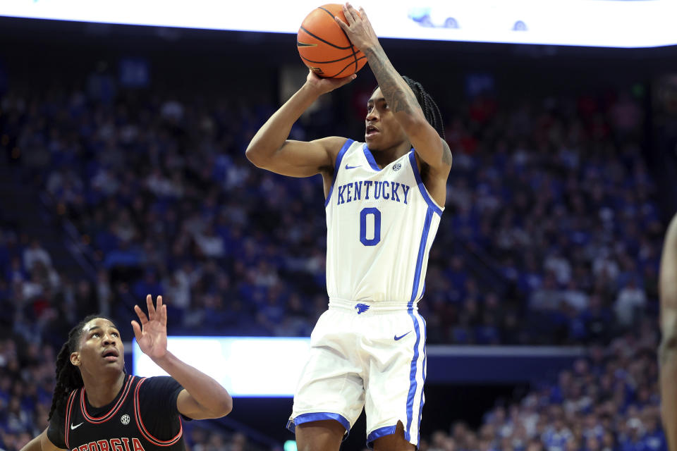 Kentucky's Rob Dillingham (0) shoots next to Georgia's Silas Demary Jr. during the first half of an NCAA college basketball game Saturday, Jan. 20, 2024, in Lexington, Ky. (AP Photo/James Crisp)