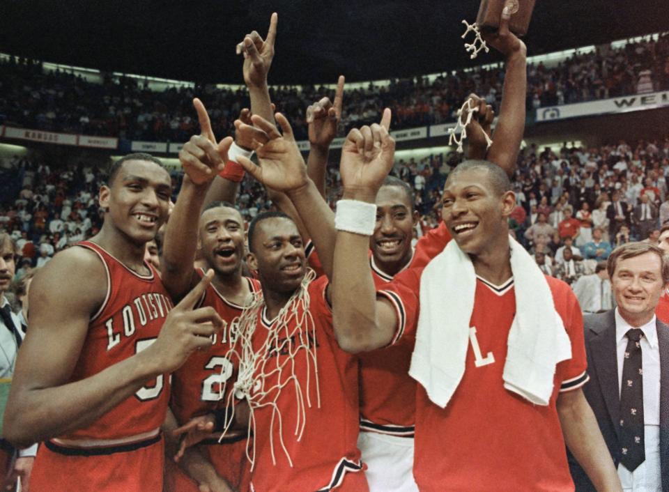 Members of the Louisville Cardinals flash the No. 1 sign after they defeated Duke at Reunion Arena to win the NCAA Championship, Monday, April 1, 1986, Dallas, Tex. From left are Billy Thompson, Milt Wagner, Kevin Walls, David Robinson and Kenny Payne.  