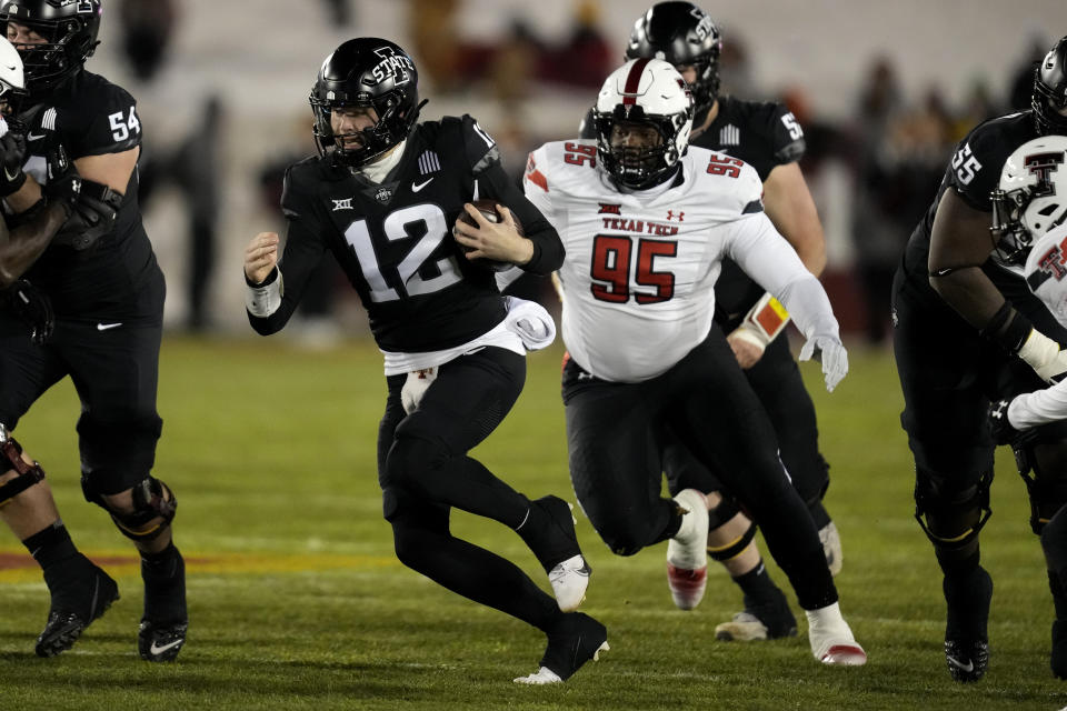 Iowa State quarterback Hunter Dekkers (12) runs from Texas Tech defensive lineman Jaylon Hutchings (95) during the first half of an NCAA college football game, Saturday, Nov. 19, 2022, in Ames, Iowa. (AP Photo/Charlie Neibergall)