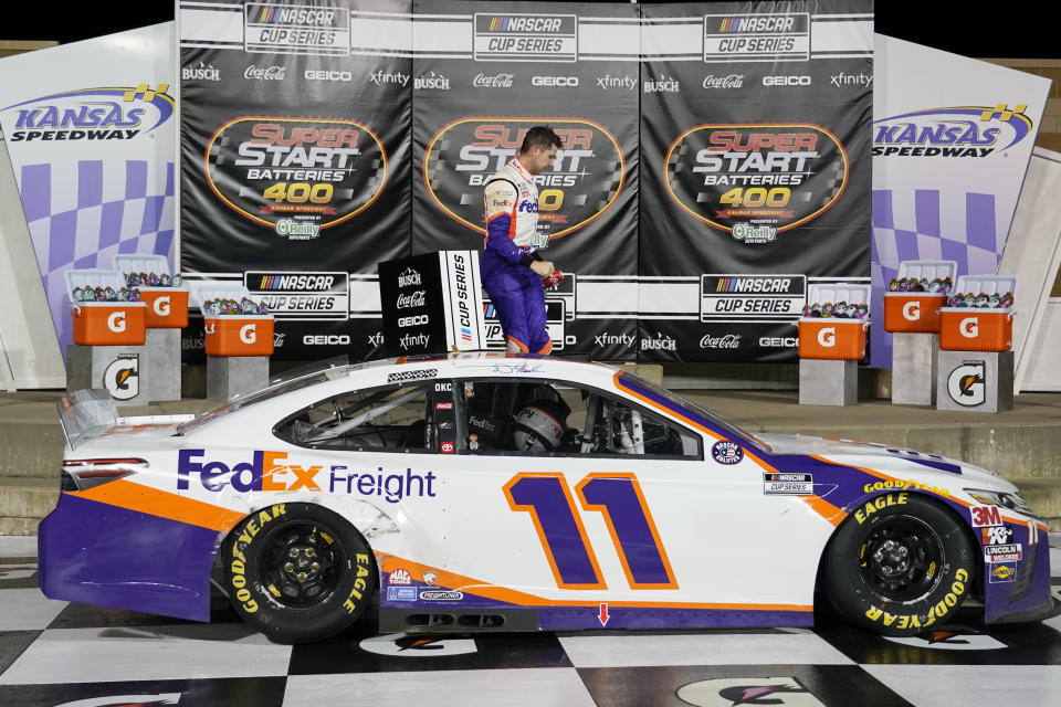 Denny Hamlin celebrates after winning a NASCAR Cup Series auto race at Kansas Speedway in Kansas City, Kan., Thursday, July 23, 2020. (AP Photo/Charlie Riedel)