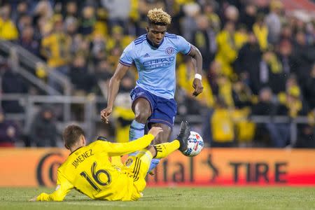 Oct 31, 2017; Columbus, OH, USA; New York City FC forward Sean Okoli (9) jumps to control a loose ball while Columbus Crew SC midfielder Hector Jimenez (16) kicks it in the second half at MAPFRE Stadium. Mandatory Credit: Trevor Ruszkowski-USA TODAY Sports