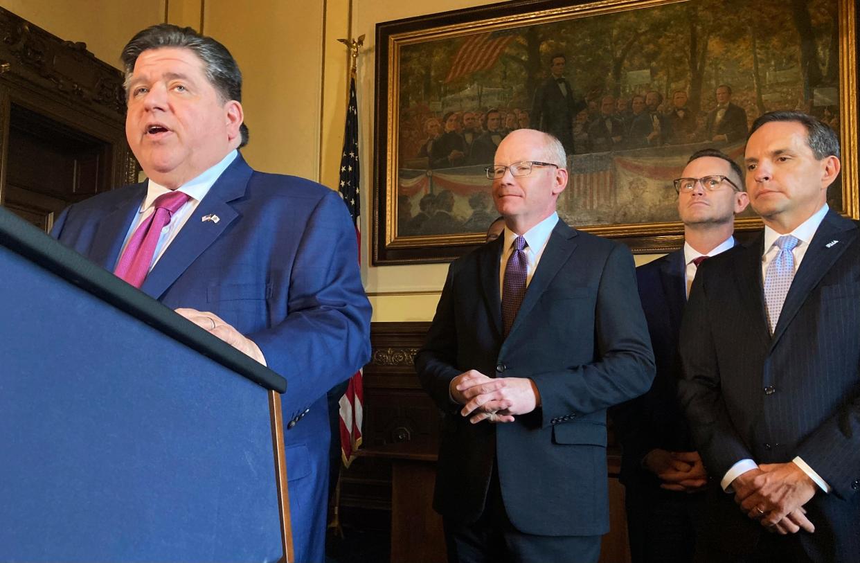 Gov. JB Pritzker announces an agreement among business and labor to eliminate a $1.8 billion deficit in the Unemployment Insurance Trust Fund in Springfield on Nov. 29, 2022. Behind him are Senate President Don Harmon, an Oak Park Democrat, Pat Devaney, secretary-treasurer of the Illinois AFL-CIO, and Rob Karr, president and CEO of the Illinois Retail Merchants Association.