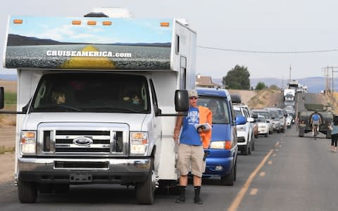 Visitors sit in stopped traffic trying to get into Solartown in Madras, Oregon - Credit:  Barcroft Media