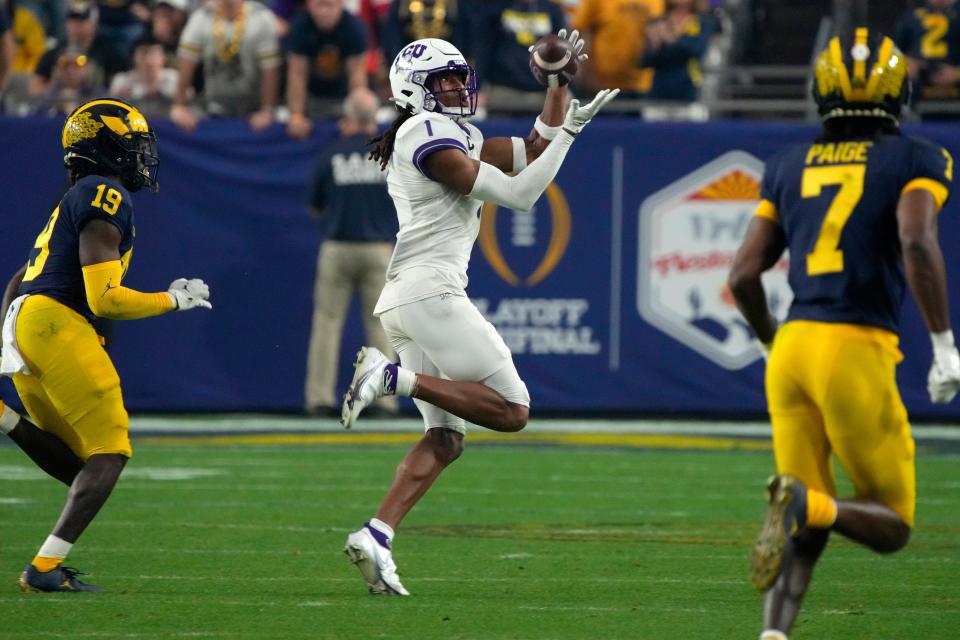 TCU wide receiver Quentin Johnston (1) makes a catch against Michigan during the second half of the Fiesta Bowl NCAA college football semifinal playoff game, Saturday, Dec. 31, 2022, in Glendale, Ariz. (AP Photo/Rick Scuteri)