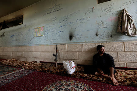 A rebel fighter from Jaysh al-Sunna, operating under a coalition of rebel groups called Jaish al-Fatah, or the army of conquest, rests in Aziziyah village, southern Aleppo countryside, Syria May 17, 2016. REUTERS/Khalil Ashawi