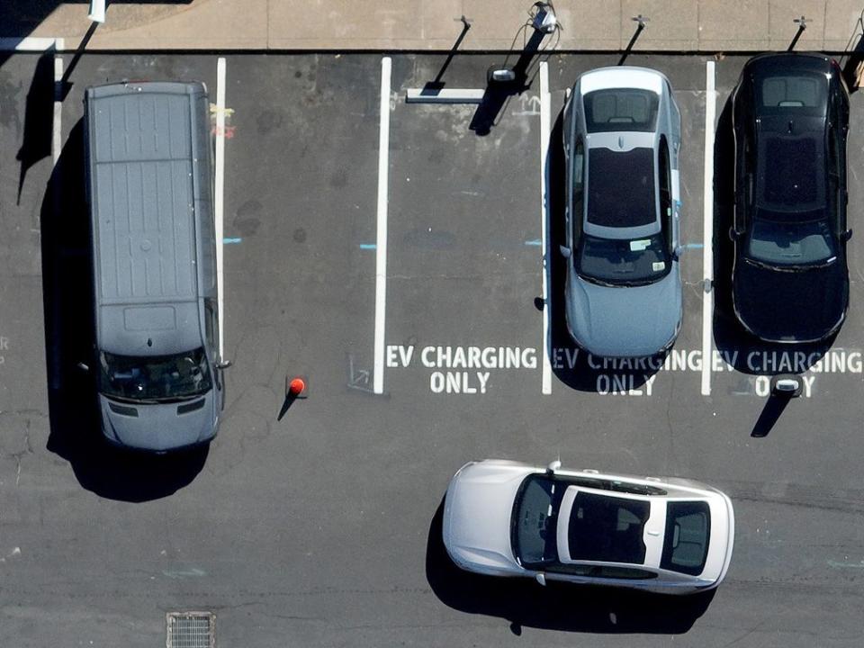  Electric cars parked at an EV charging station.