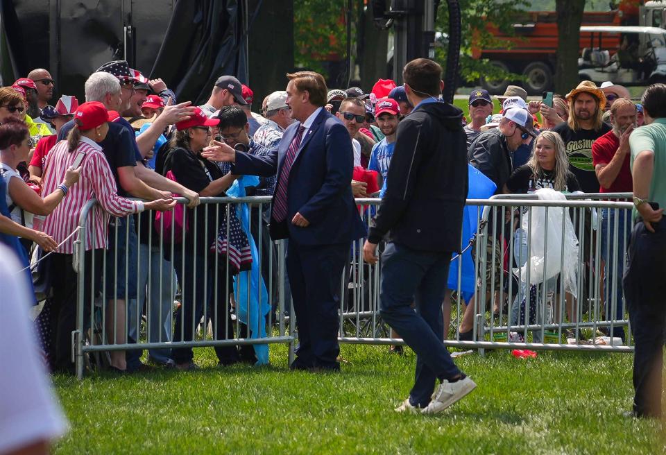 My Pillow CEO Mike Lindell greets supporters of former President Donald Trump during a rally at the Lauridsen Amphitheater at Water Works Park in Des Moines on Saturday, May 13, 2023. The event was later postponed due to weather.