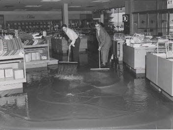 Hurricane Carol, August 1954: Workers clear water from R.H. White department store in Lincoln Plaza in Worcester.