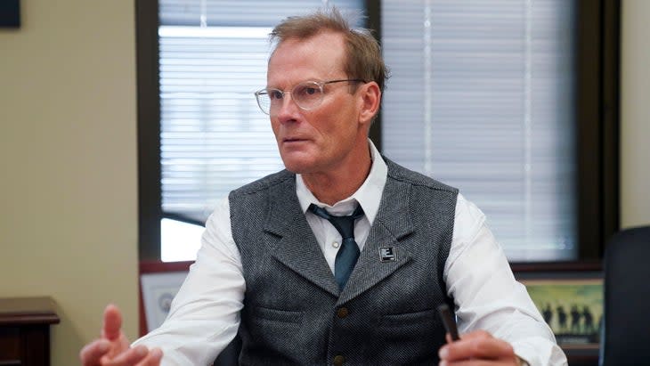 Man in a suit speaking in a board room