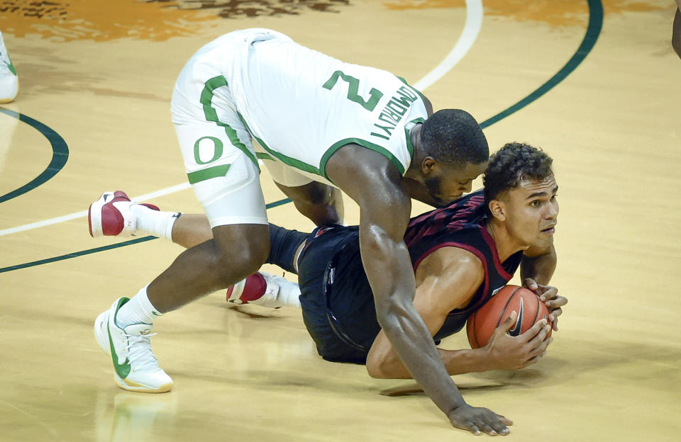 Oregon forward Eugene Omoruyi (2) fouls Stanford forward Oscar da Silva (13) during the second half of an NCAA college basketball game Saturday, Jan. 2, 2021 in Eugene, Ore. Oregon won the game 73-56. (AP Photo/Andy Nelson)