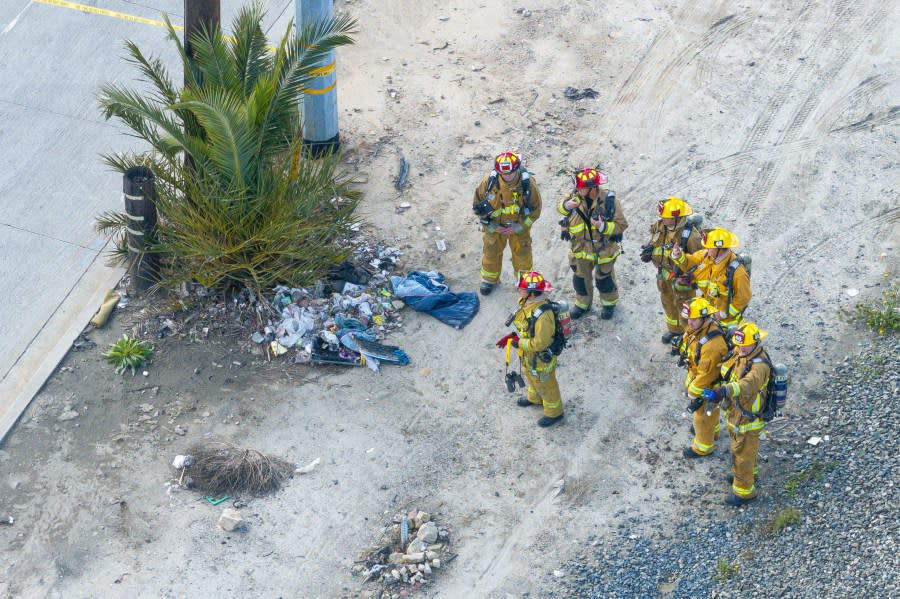 Firefighters stage at the scene of an explosion in an aerial view on Thursday, Feb. 15, 2024, in the Wilmington section of Los Angeles. Several Los Angeles firefighters were injured, two critically, when an explosion occurred as they responded to a truck with pressurized cylinders that were on fire early Thursday, authorities said. (AP Photo/William Liang)