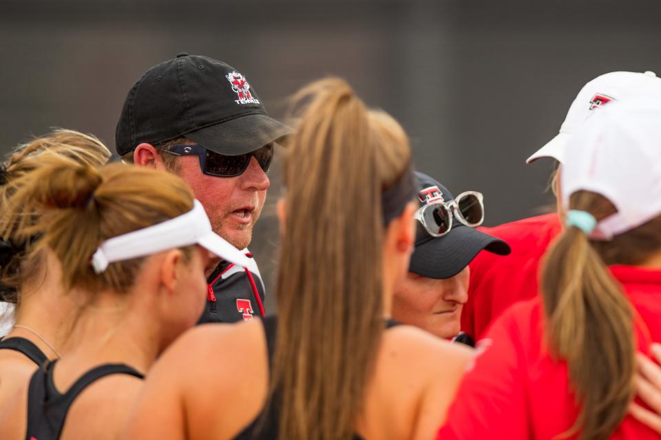 Todd Petty, shown talking to his players during a match against Oklahoma State on April 1, stepped down as women's tennis coach June 30.