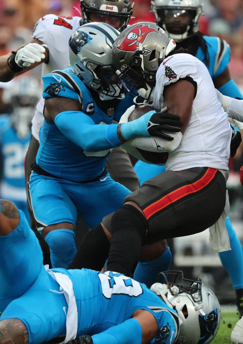 Dec 3, 2023; Tampa, Florida, USA; Carolina Panthers linebacker Brian Burns (0) tackles Tampa Bay Buccaneers running back Rachaad White (1) during the first quarter at Raymond James Stadium. Mandatory Credit: Kim Klement Neitzel-USA TODAY Sports