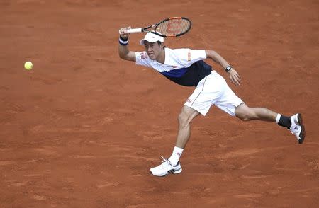 Kei Nishikori of Japan plays a shot to Thomaz Bellucci of Brazil during their men's singles match at the French Open tennis tournament at the Roland Garros stadium in Paris, France, May 27, 2015. REUTERS/Gonzalo Fuentes