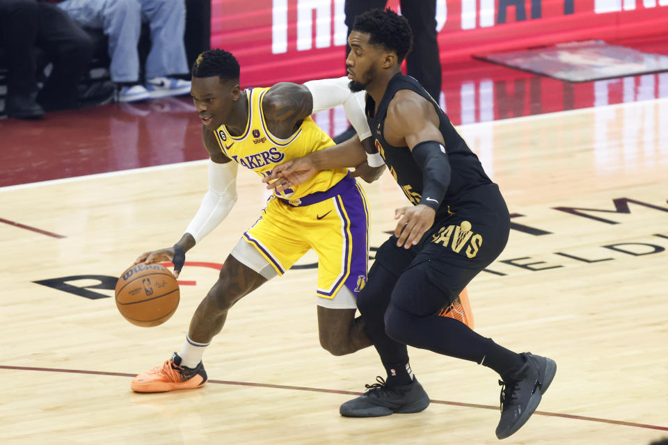 Los Angeles Lakers guard Dennis Schroder (17) drives against Cleveland Cavaliers guard Donovan Mitchell during the first half of an NBA basketball game Tuesday, Dec. 6, 2022, in Cleveland. (AP Photo/Ron Schwane)