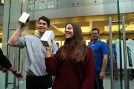 SYDNEY, AUSTRALIA - SEPTEMBER 21: The first customers to purchase their new iPhone 5 phone's exit the Apple flagship store on George street on September 21, 2012 in Sydney, Australia. Australian Apple stores are the first in the world to receive and sell the new iPhone 5 handsets. (Photo by Cameron Spencer/Getty Images)