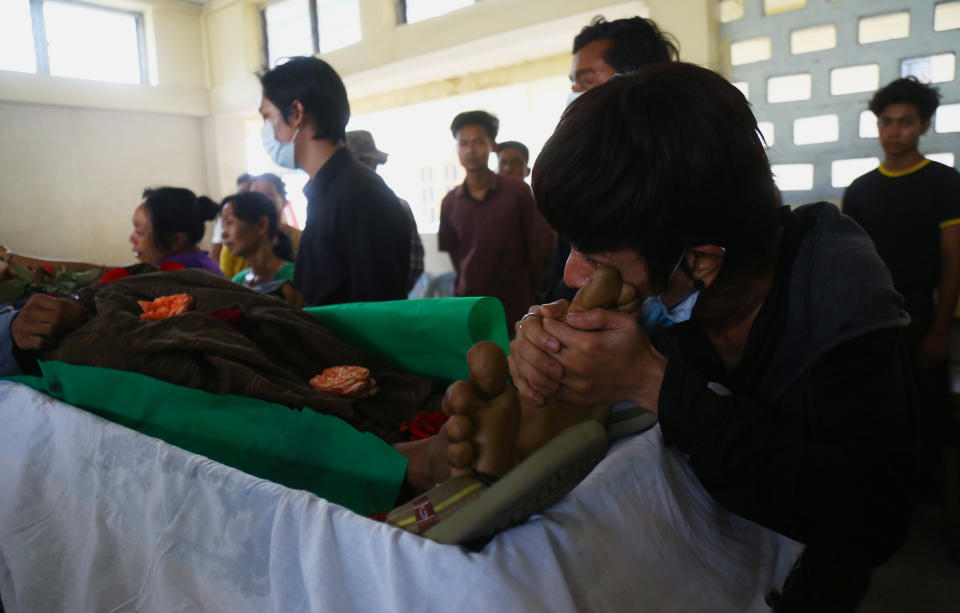 A family member mourns over the death of Aung Myo Thant as they gather at his funeral in Yangon, Myanmar, Tuesday, March 30, 2021. Family members said Aung Myo Thant was killed Monday during a clash with security forces at a protest against the military's coup that ousted the government of Aung San Suu Kyi on Feb. 1. (AP Photo)