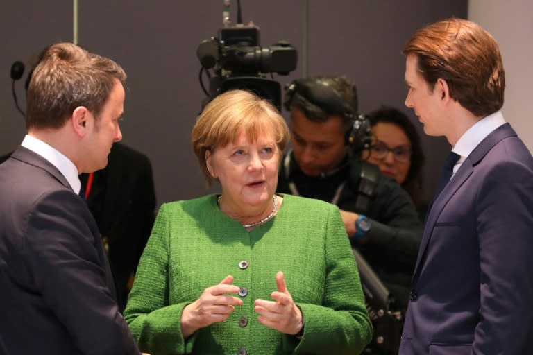 Germany's Chancellor Angela Merkel (C) speaks with Luxembourg's Prime Minister Xavier Bettel (L) and Austria's Chancellor Sebastian Kurz at EU meeting where she has proposed a controversial plan to tie regional funding for poorer states to the willingness to take in refugees