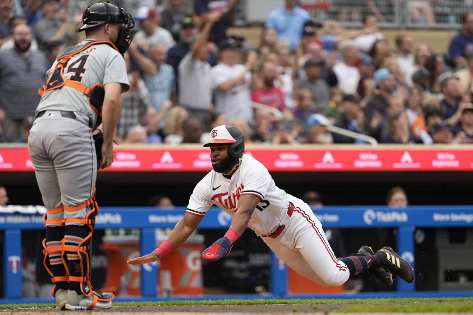 Minnesota Twins' Manuel Margot dives to score off a two-run double during the third inning of a baseball game against the Detroit Tigers, Tuesday, July 2, 2024, in Minneapolis. (AP Photo/Abbie Parr)