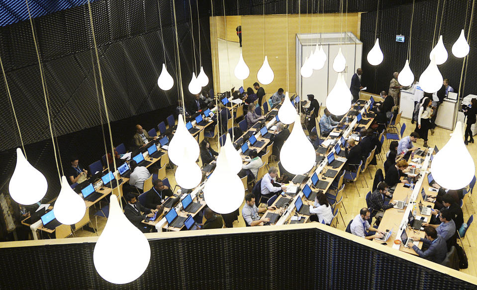 Participants work in a computer room during the Climate Change Conference COP24 in Katowice, Poland, Tuesday, Dec. 4, 2018. (AP Photo/Czarek Sokolowski)