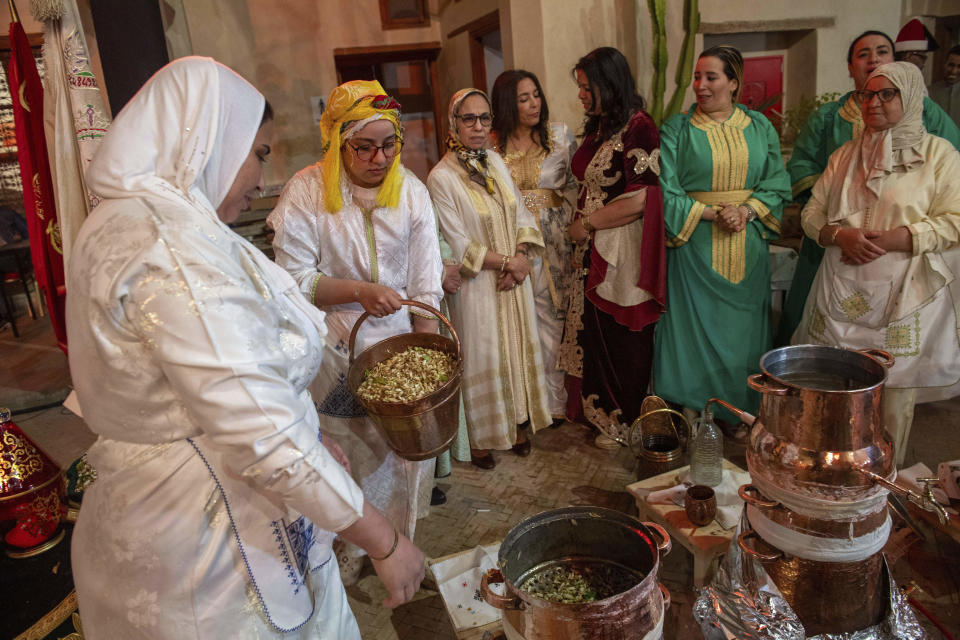 Women prepare to distill orange blossoms in a cultural center in Marrakech, Morocco, Saturday, March 23, 2024. Moroccan cities are heralding in this year's spring with orange blossoms by distilling them using traditional methods. Orange blossom water is mostly used in Moroccan pastries or mint tea and sprinkled over heads and hands in religious ceremonies. (AP Photo/Mosa'ab Elshamy)