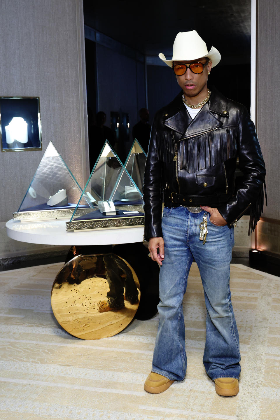 Pharrell Williams attends as Tiffany & Co. celebrates the debut of the Tiffany Titan in tan clog boots