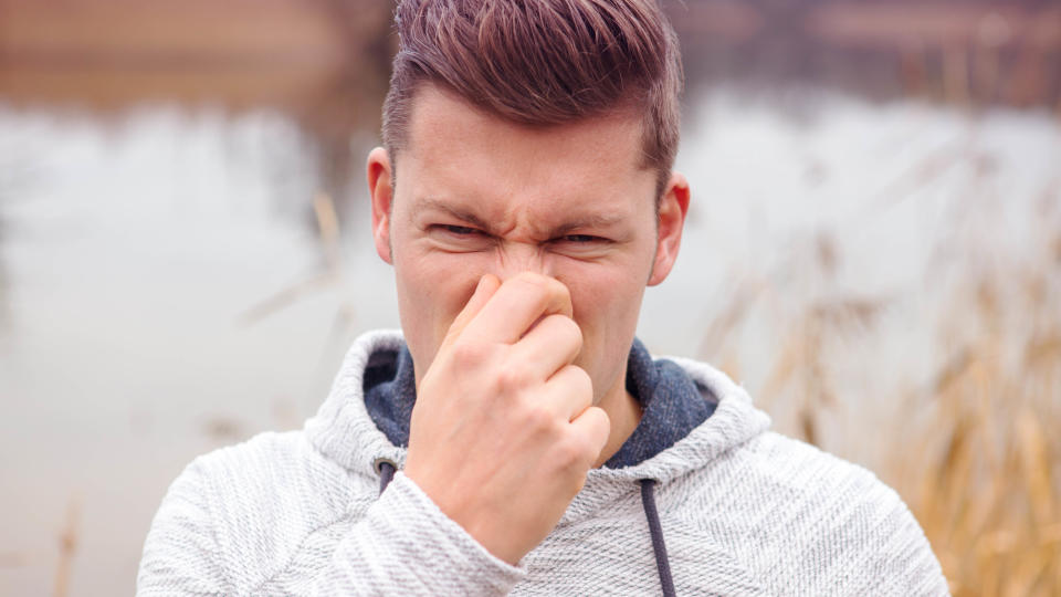 Man holding his nose