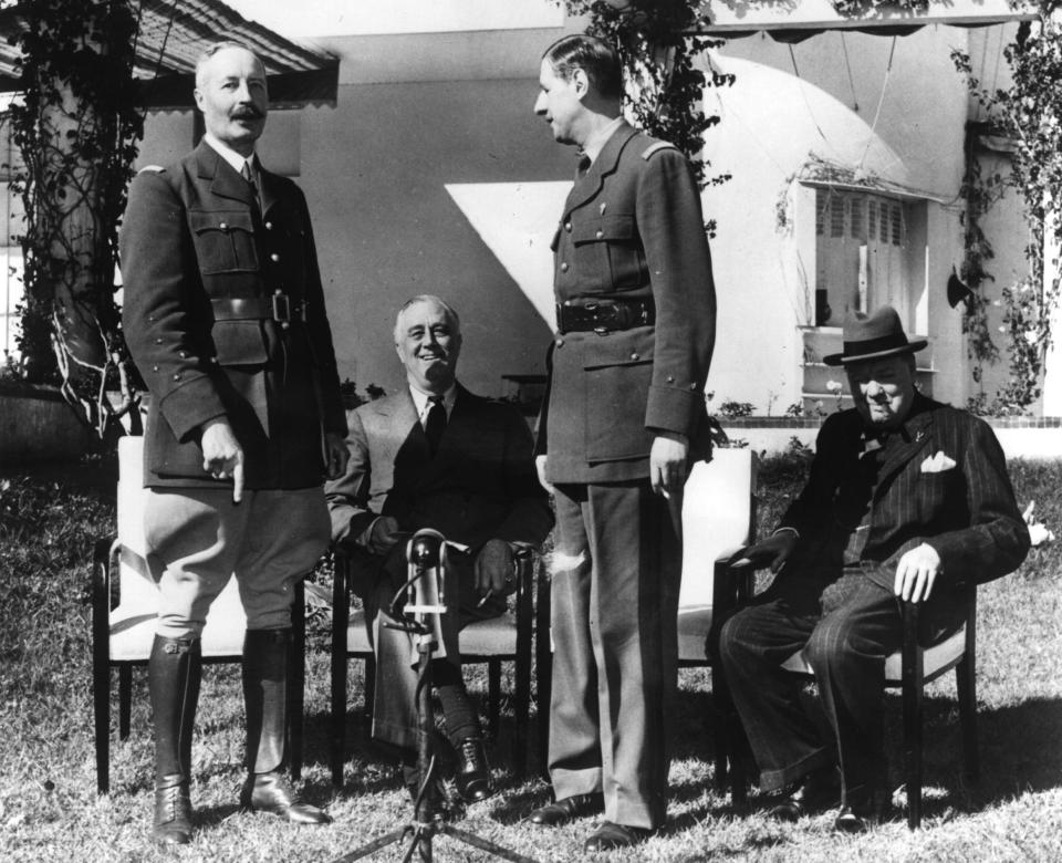 General Henri Honore Giraud and General Charles De Gaulle stand in front of American President Franklin Delano Roosevelt and British Prime Minister Winston Churchill at the Casablanca Conference.