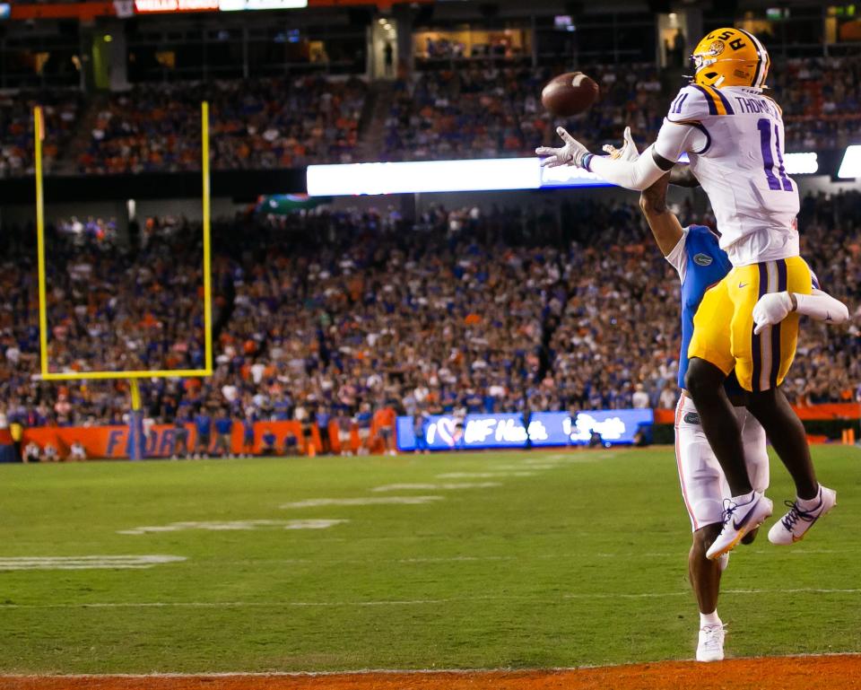 Florida Gators cornerback Jalen Kimber (8) tries to defend LSU Tigers wide receiver Brian Thomas Jr. (11) as Thomas pulls in a reception for a touchdown in the first half at Steve Spurrier Field at Ben Hill Griffin Stadium in Gainesville, FL on Saturday, October 15, 2022. [Doug Engle/Gainesville Sun]