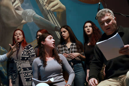 Actors and choir members practice during a text rehearsal of "The Slobodan Show" play in Belgrade, Serbia, January 20, 2018. Picture taken January 20, 2018. REUTERS/Djordje Kojadinovic