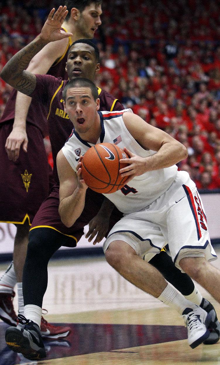 Arizona's T.J. McConnell (4) drives past Arizona State's Jahil Carson in the first half of an NCAA college basketball game on Thursday, Jan. 16, 2014, in Tucson, Ariz. (AP Photo/John Miller)