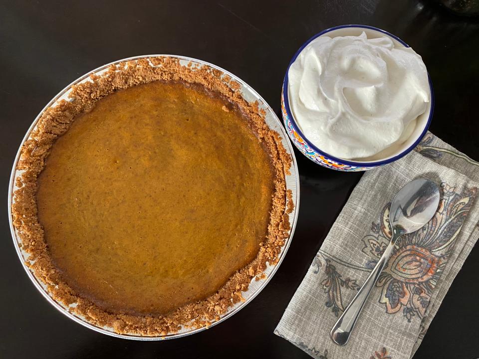 Bobby Flay final whole pie with whipped cream and a spoon on a napkin