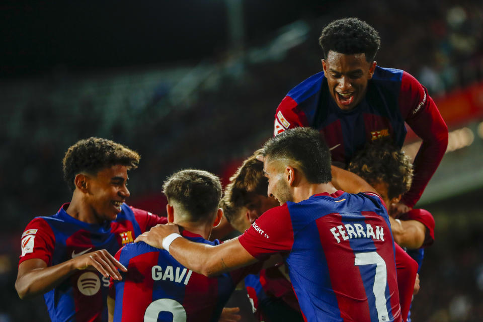 Barcelona's Marc Guiu celebrates with teammates after scoring his side's opening goal during a Spanish La Liga soccer match between Barcelona and Athletic Bilbao, at the Olympic Stadium of Montjuic in Barcelona, Spain, Sunday, Oct. 22, 2023. (AP Photo/Joan Monfort )