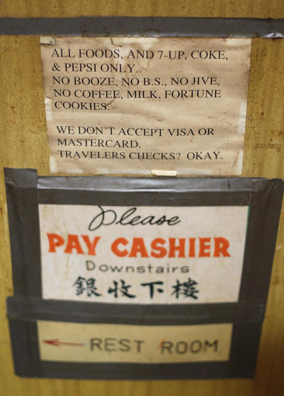Signs taped to the walls from long ago are shown inside the Sam Wo restaurant in Chinatown in San Francisco, Friday, April 20, 2012. The 100-year-old Chinese restaurant known for having "the world's rudest waiter" is shutting its doors and serving its last customers Friday. (AP Photo/Eric Risberg)