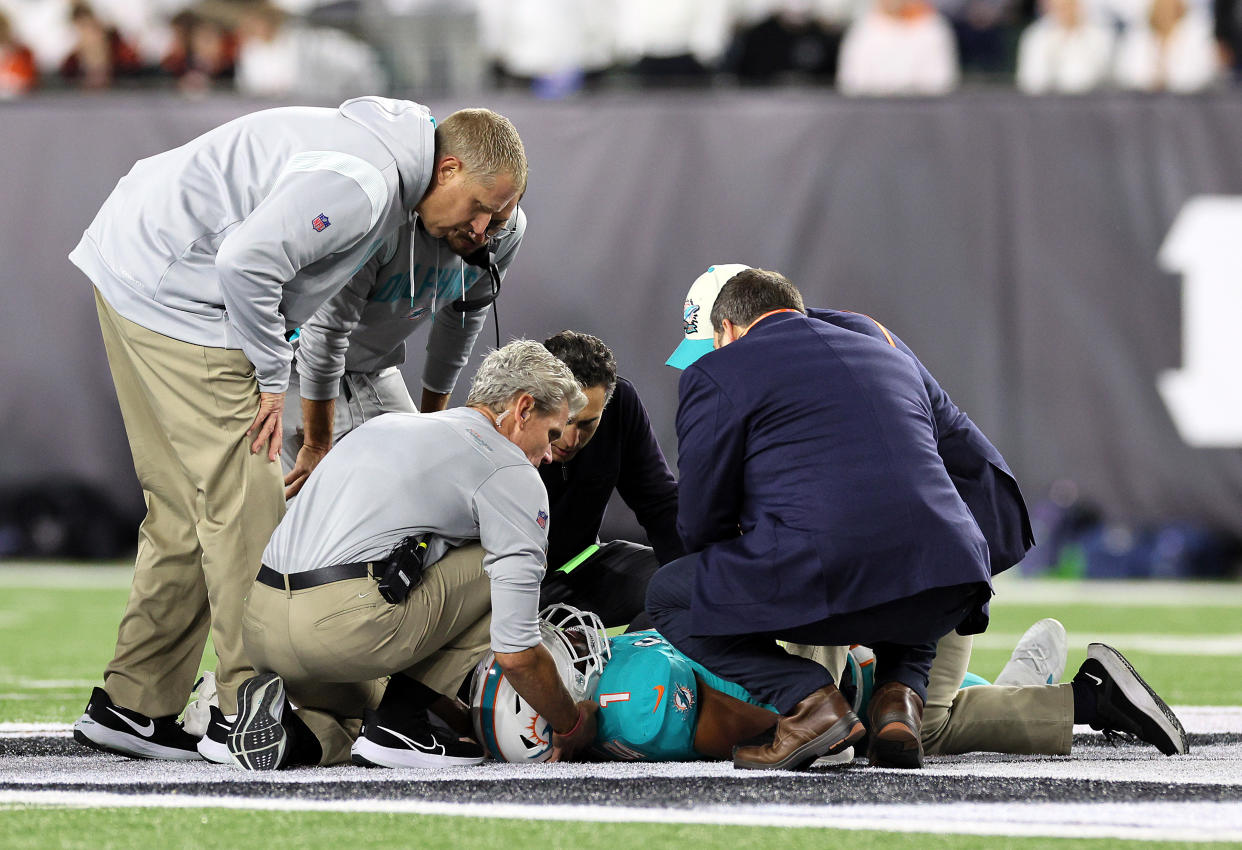 Medical staff tend to quarterback Tua Tagovailoa of the Miami Dolphins after an injury against the Bengals. (Photo by Andy Lyons/Getty Images)