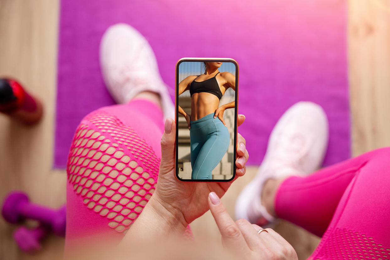 Woman holding mobile phone during fitness training - Credit: Photo illustration includes images from Adobe Stock, 2