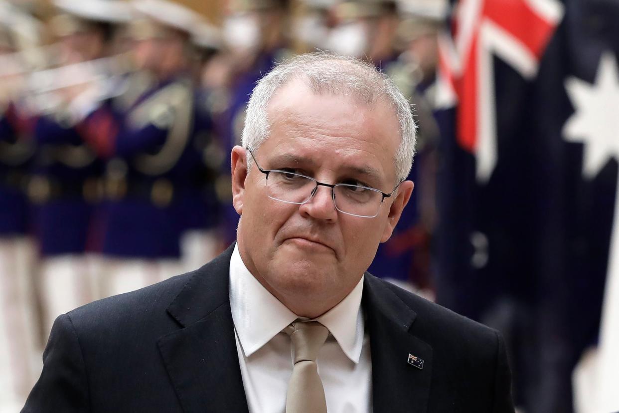 <p>Australian Prime Minister Scott Morrison reviews an honor guard during a ceremony </p> (AP)