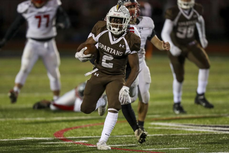 Roger Bacon running back Jah'mal Hutsell (2) runs the ball in for a touchdown against Preble Shawnee in the first half at Lakota West High School, Nov. 13, 2021.