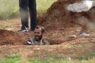 A rebel fighter from 'Jaysh al-Sunna' is seen in a trench during what they said was an offensive to take control of al-Mastouma military camp which is controlled by forces loyal to Syria's President Bashar al-Assad beside Idlib city May 12, 2015. REUTERS/Khalil Ashawi